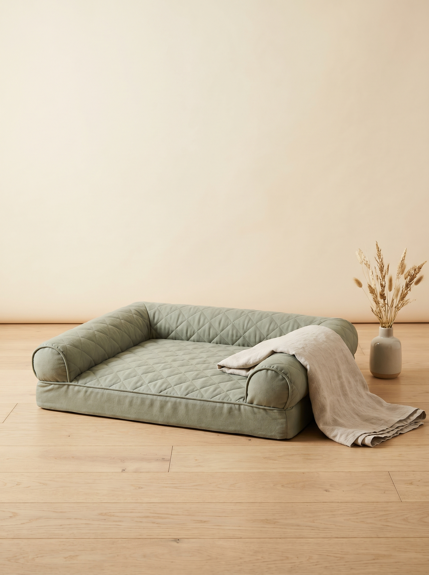 NOORYN sage-green orthopaedic pet bed styled in a calm cream room